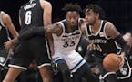 Brooklyn Nets guard D'Angelo Russell (1) drives to the basket against Minnesota Timberwolves forward Robert Covington (33) during the first half of an