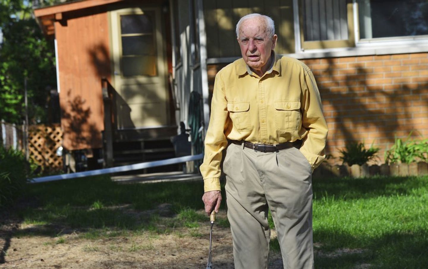 In this May 2014 photo, Michael Karkoc works in his yard in Minneapolis.