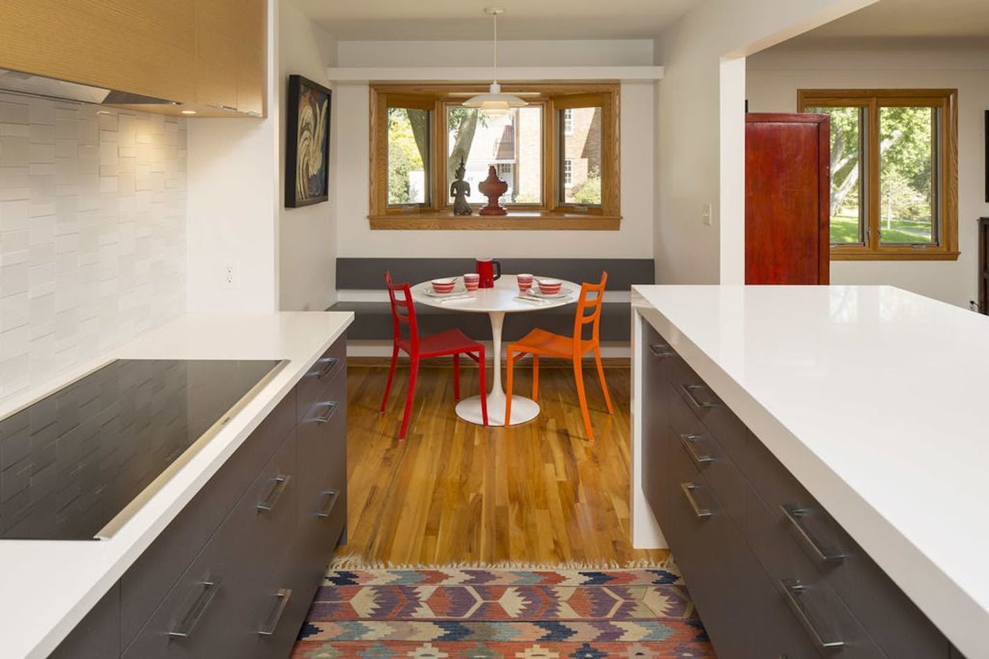 AFTER In the breakfast nook, a new bench beneath the existing bay window "gives the wall a purpose — and more seating," said architect Meghan Kell Cornell.