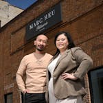 Marc and Gaosong Heu outside the new Marc Heu Patisserie Paris at Selby and Dale in St. Paul.