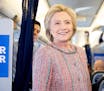 Democratic presidential candidate Hillary Clinton smiles as she speaks with members of the media on her campaign plane, in White Plains, N.Y., Thursda