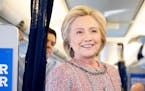 Democratic presidential candidate Hillary Clinton smiles as she speaks with members of the media on her campaign plane, in White Plains, N.Y., Thursda