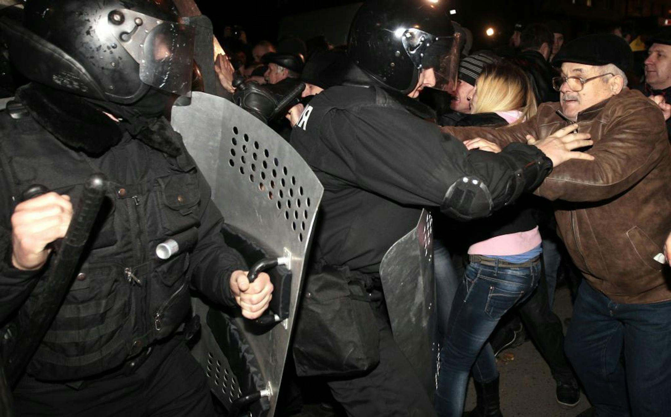 Ukrainian riot police officers block pro-Russian supporters of activist Pavel Gubarev during a rally in Donetsk, Ukraine, Thursday, March 6, 2014.