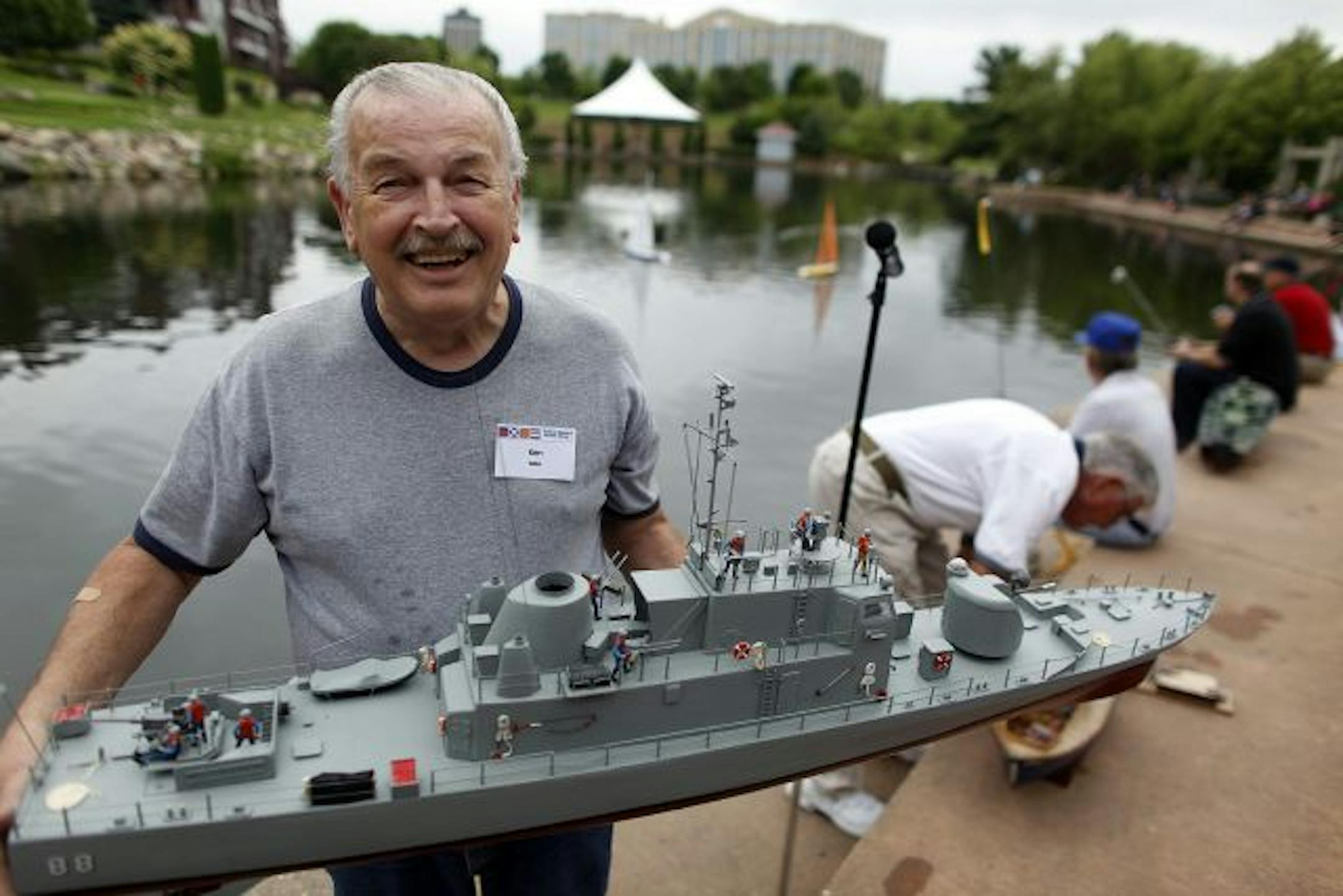 Ken Moe, a member of the Edina Model Yacht Club, prepared to launch his model warship.