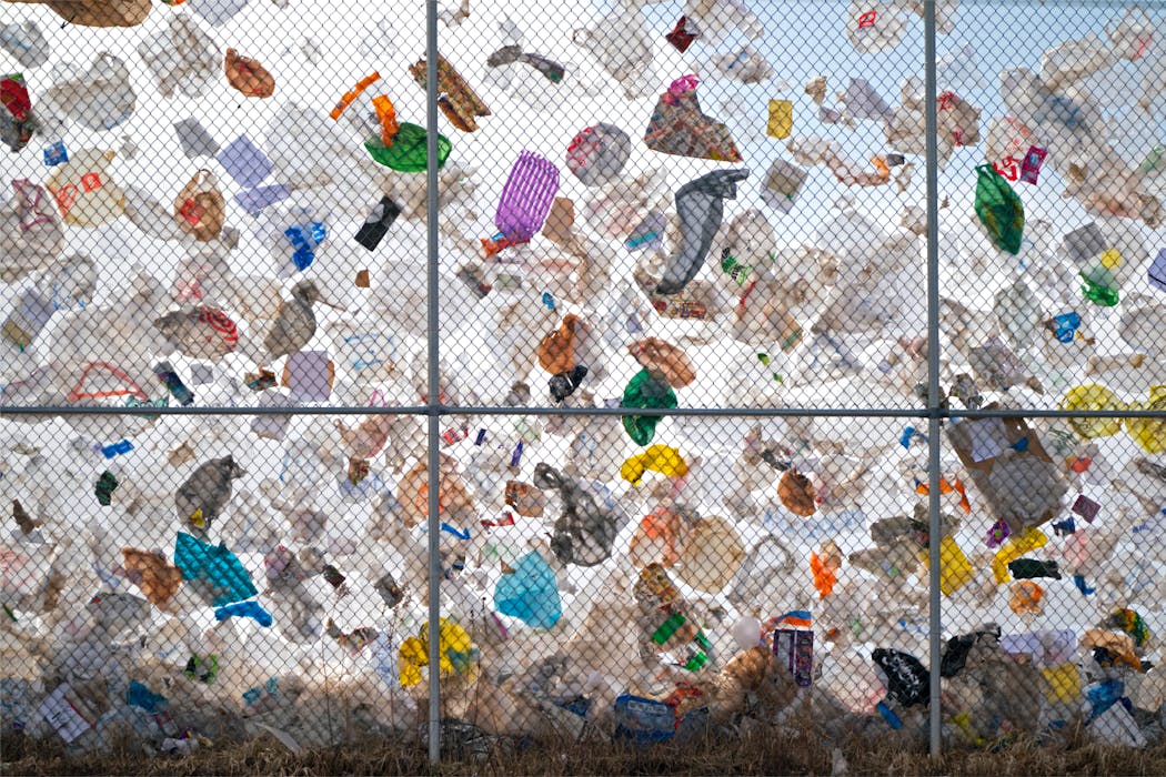 Bags and other plastic film clung to the fence of Waste Management's Elk River landfill on a windy day in 2021.