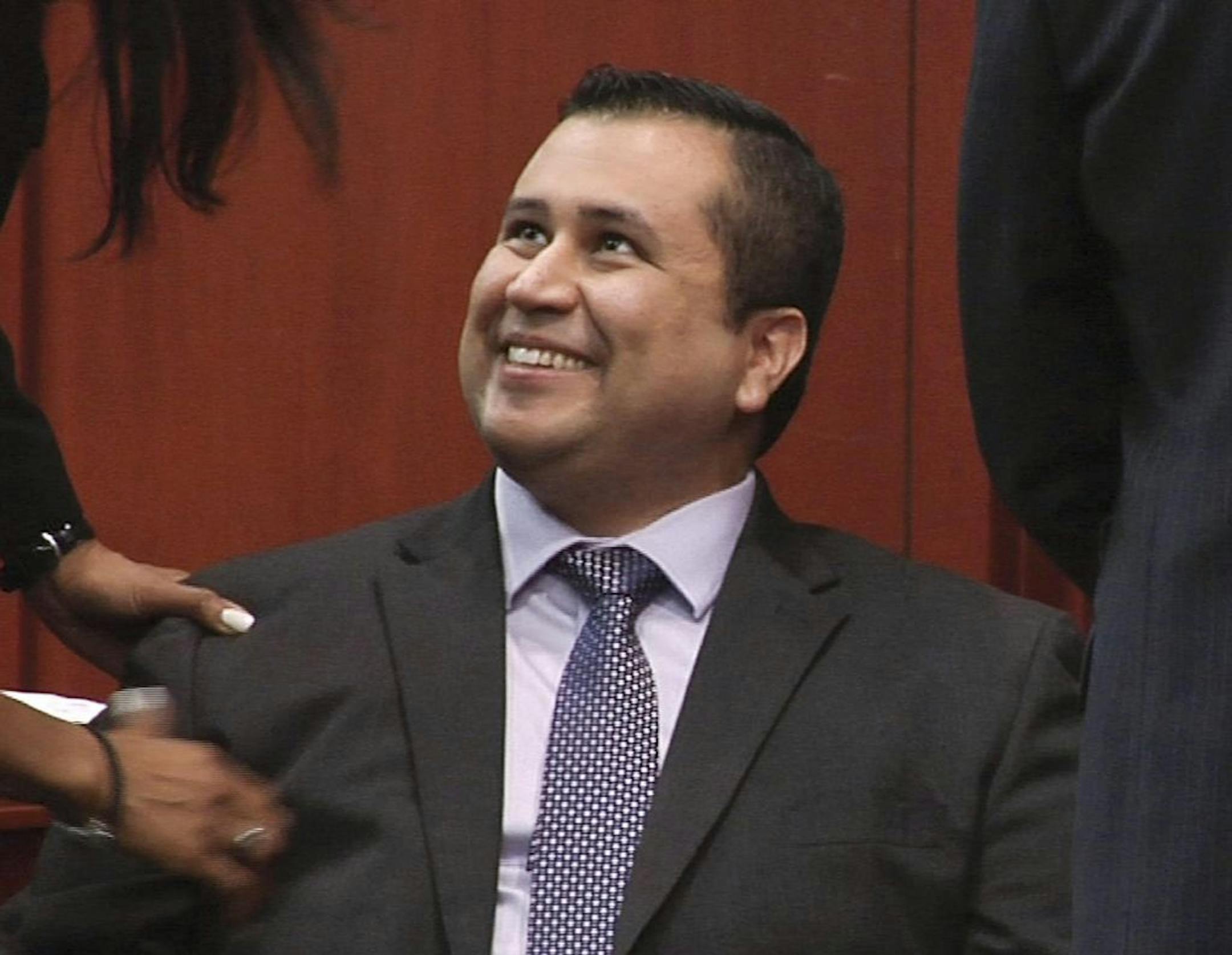 In this image from video, George Zimmerman smiles after a not guilty verdict was handed down in his trial at the Seminole County Courthouse, Sunday, July 14, 2013, in Sanford, Fla. Neighborhood watch captain George Zimmerman was cleared of all charges Saturday in the shooting of Trayvon Martin, the unarmed black teenager whose killing unleashed furious debate across the U.S. over racial profiling, self-defense and equal justice.
