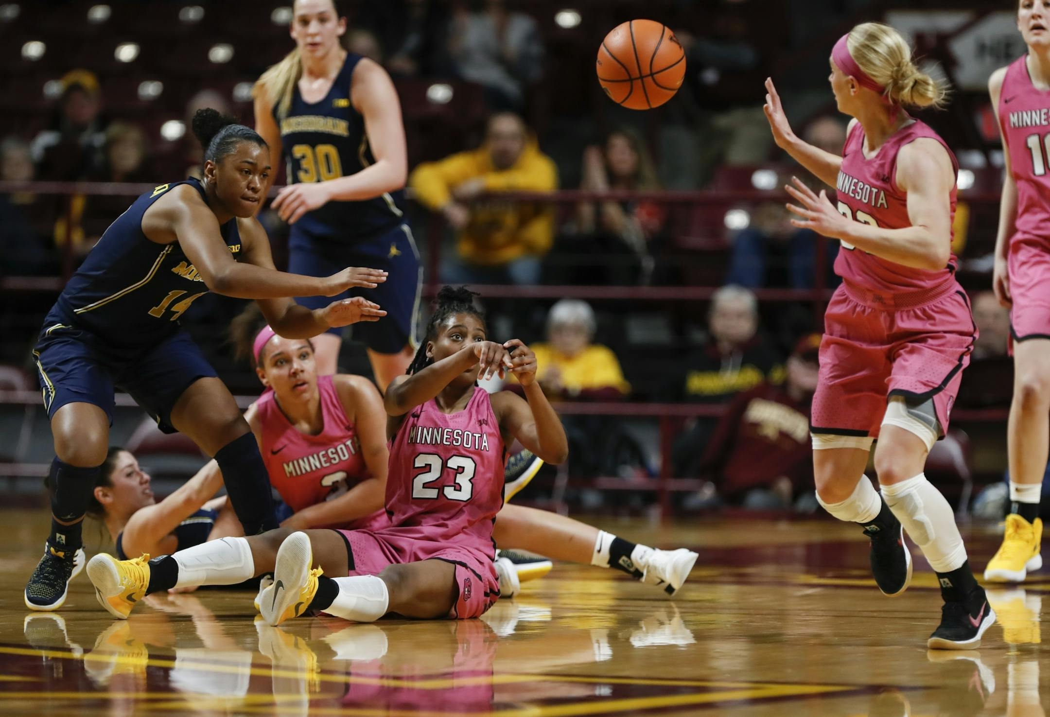 Minnesota Golden Gophers guard Kenisha Bell (23) past a stolen ball to Minnesota Golden Gophers guard Carlie Wagner (33) in the first half.