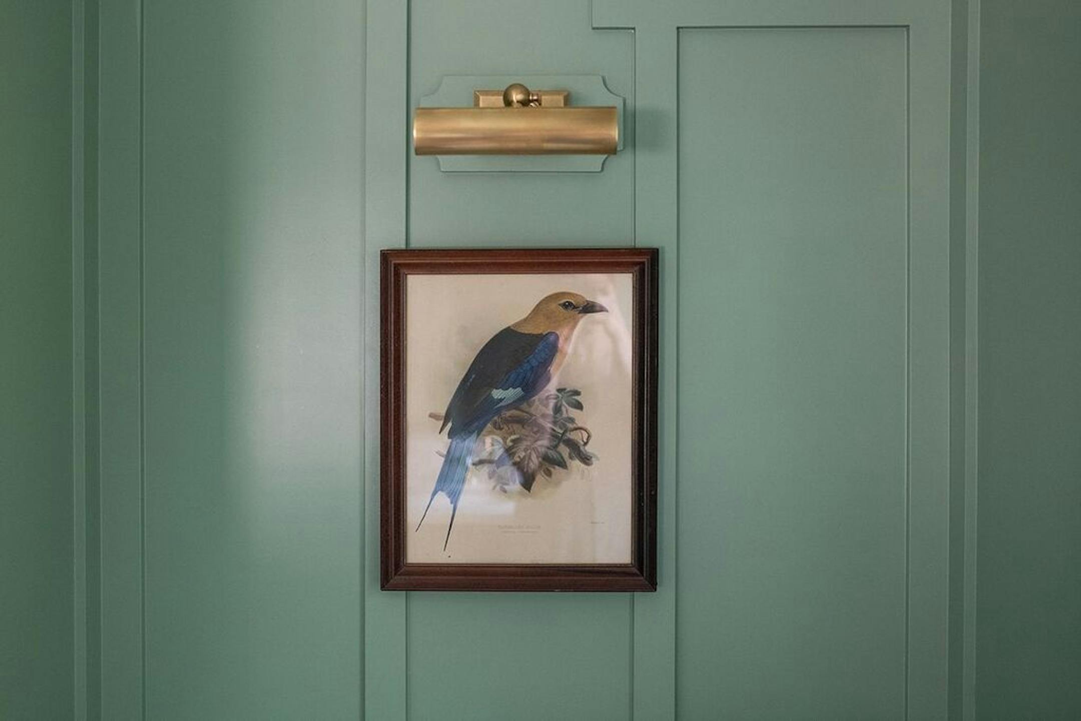 A vintage bird print hangs in the bathroom.