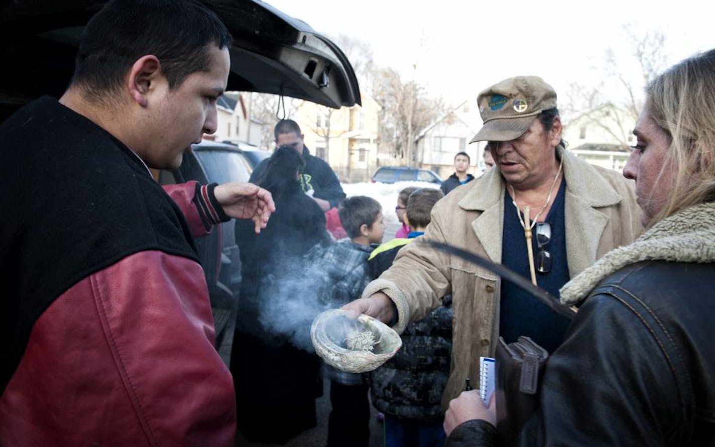 Bob Klanderud performed a sage-smudging ceremony for some former Red Lake students who stopped Wednesday in Minneapolis on their way to comfort families in Newtown, Conn.