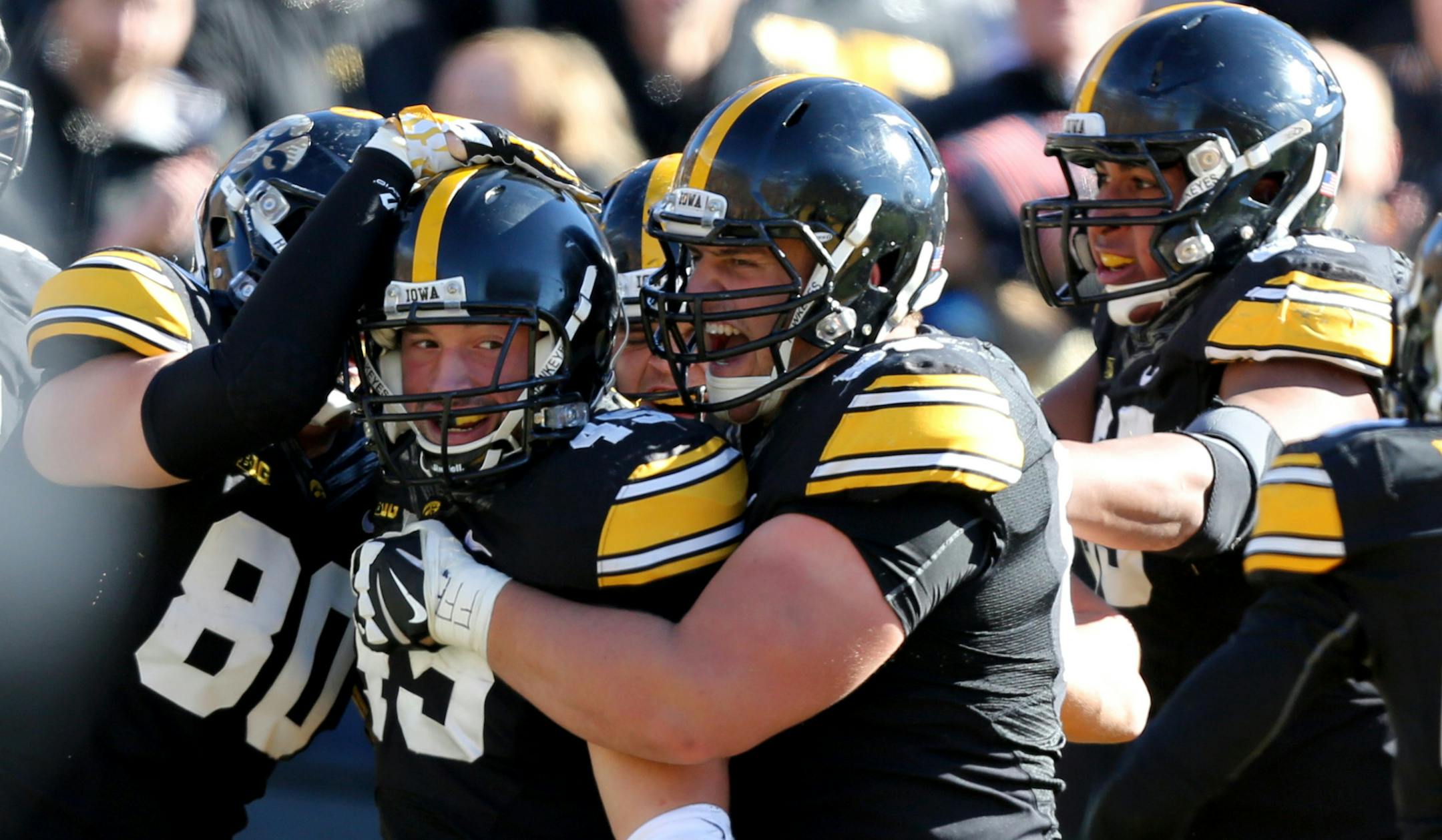 Iowa running back Mark Weisman (45) is mobbed by his teammates after scoring a touchdown during the first half of an NCAA college football game against Northwestern, Saturday, Nov. 1, 2014, in Iowa City, Iowa. Iowa won 48-7. (Justin Hayworth/AP Photo) ORG XMIT: IAJH108