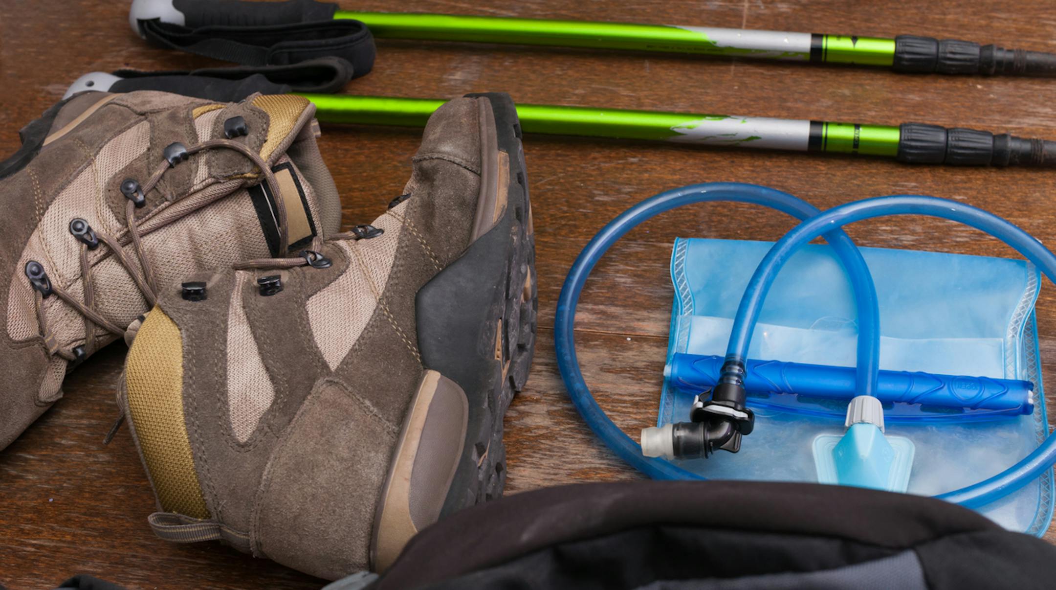 Closeup shot of various tools and equipment for a hiker laid out on a table