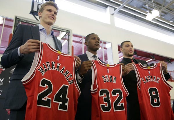 Chicago Bulls seventh overall draft pick Lauri Markkanen, left, Kris Dunn, center, and Zach Levine, pose for a photo at the NBA basketball team's trai
