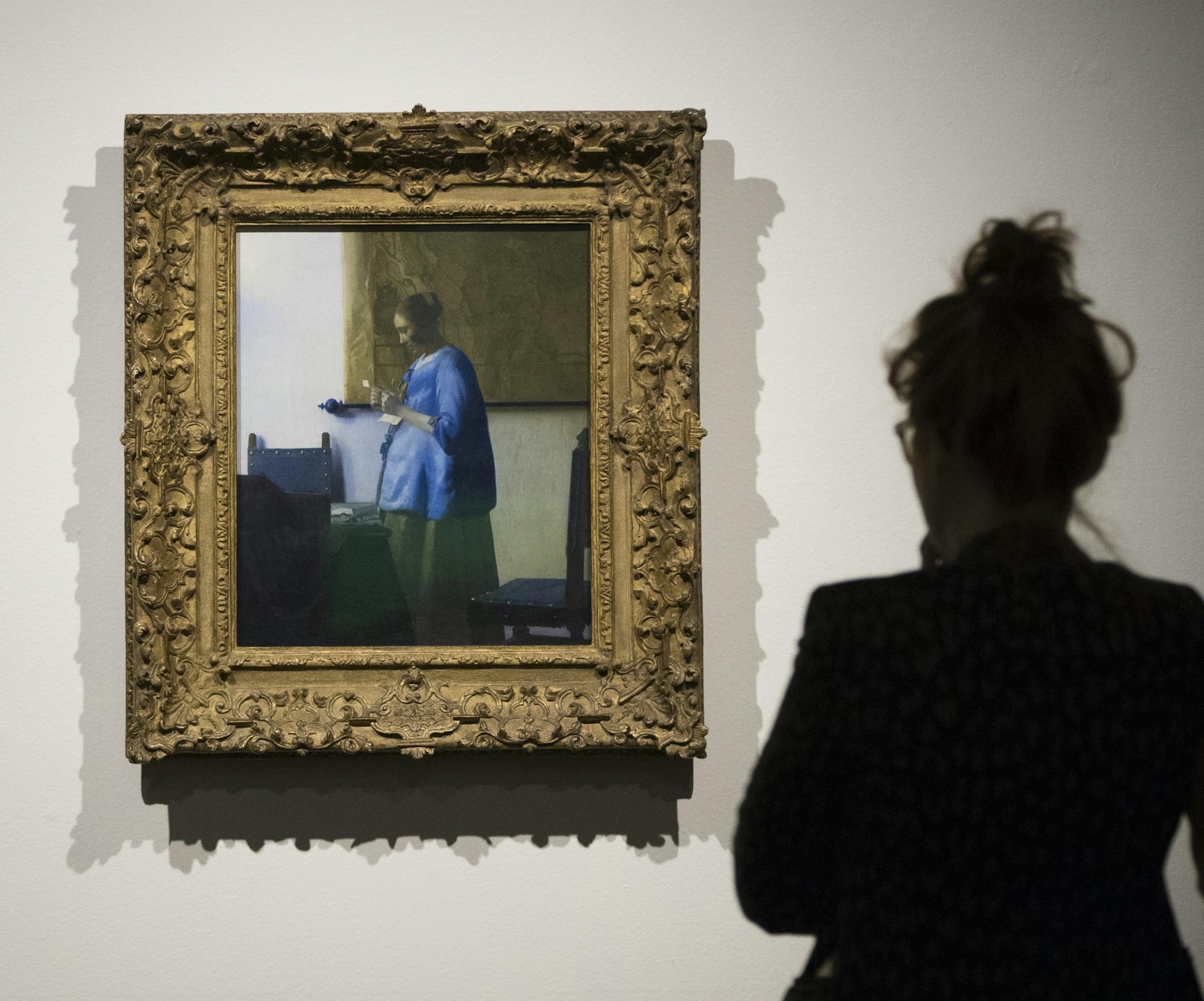 MIA staff members got a close up look at Johannes Vermeer's Woman in Blue Reading a Letter at the staff unveiling of the Minneapolis Institute of Arts' first big "surprise" of its centennial year on Friday, January 16, 2015, in Mineapolis, Minn. ] RENEE JONES SCHNEIDER &#x2022; renee.jones@yahoo.com