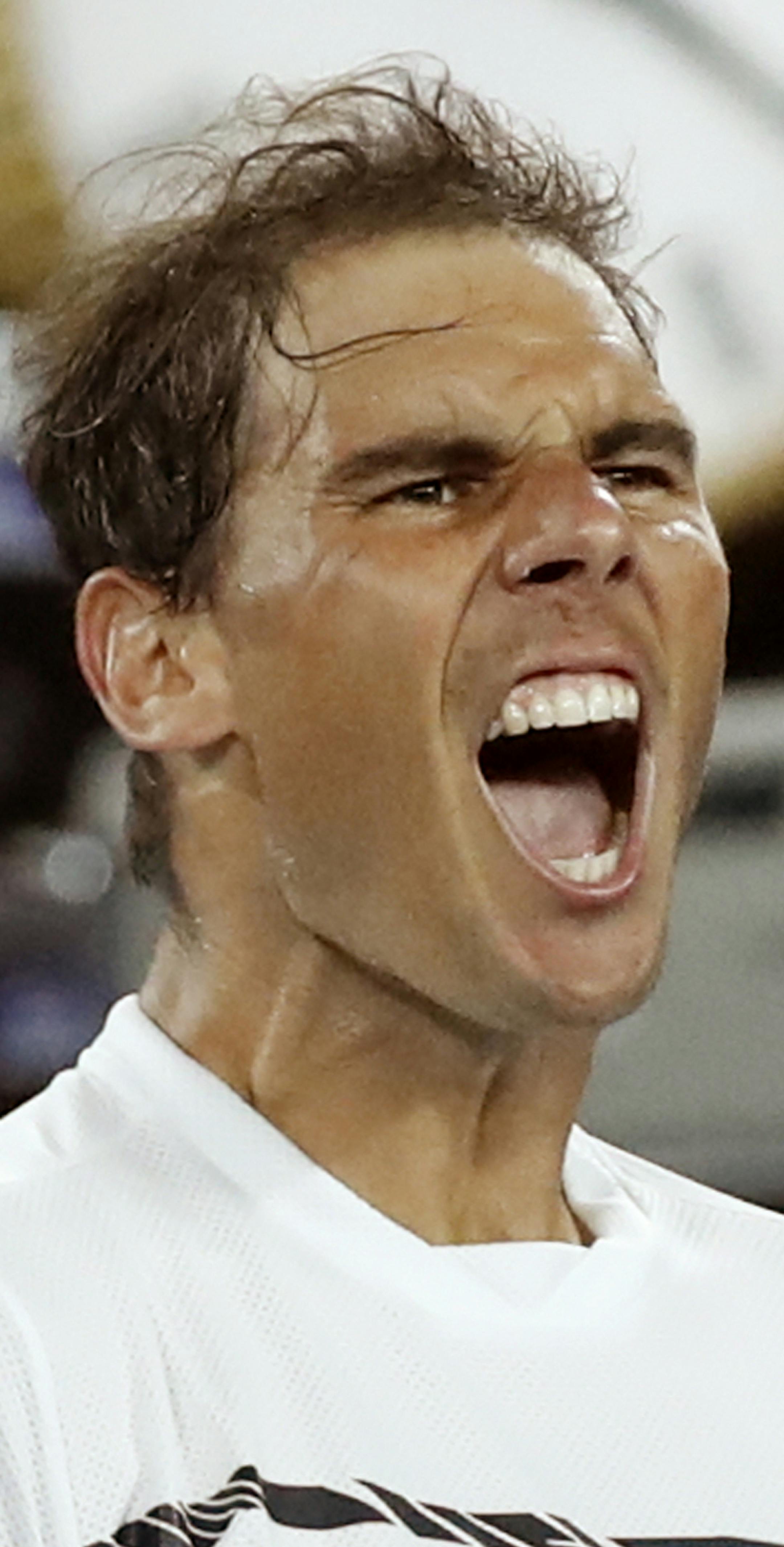 Spain's Rafael Nadal celebrates after defeating Canada's Milos Raonic during their quarterfinal at the Australian Open tennis championships in Melbourne, Australia, Wednesday, Jan. 25, 2017. (AP Photo/Kin Cheung)