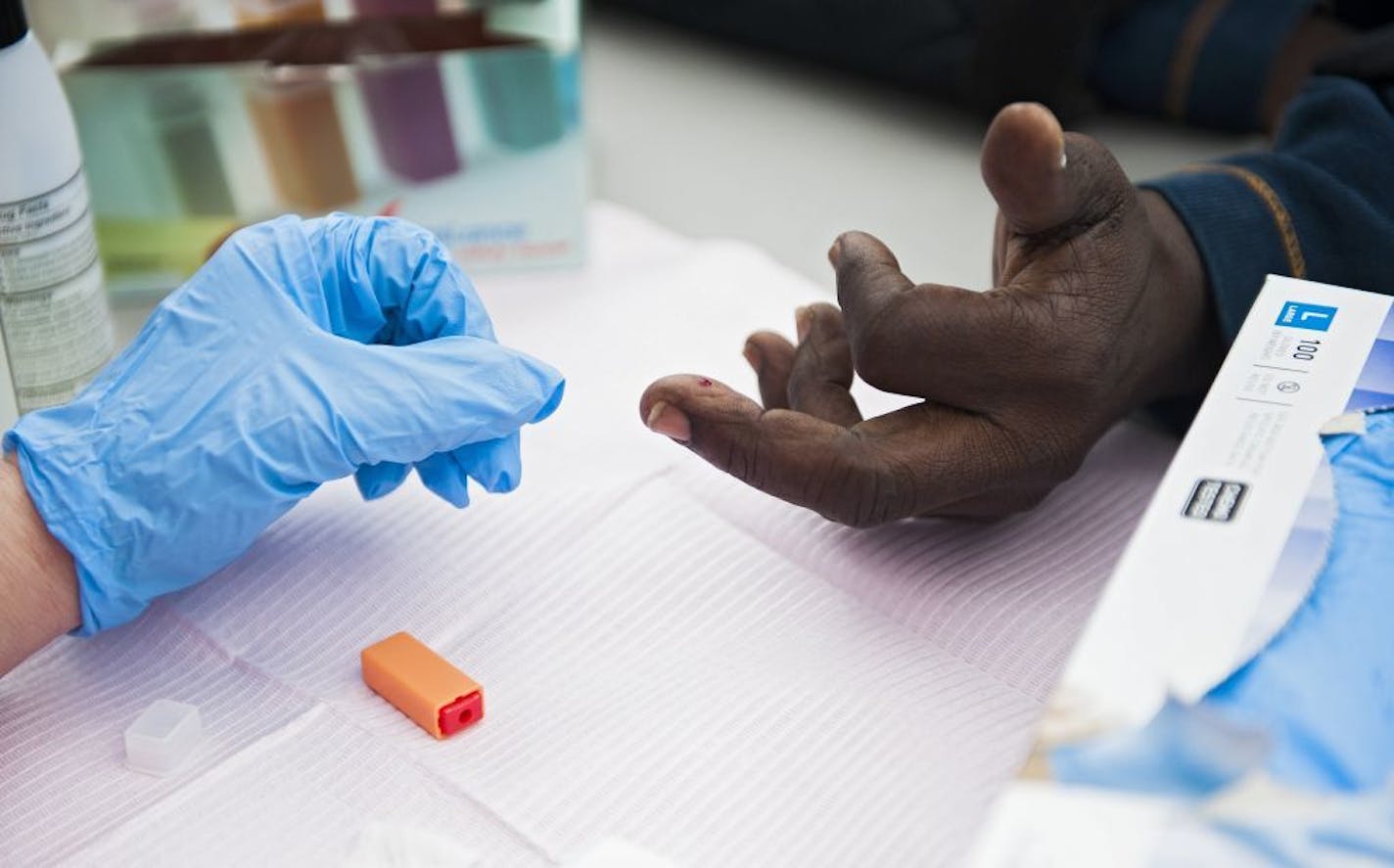 A blood glucose level test is administered on a participant in a research trial that provides appropriate food, doctor referrals, diabetes education and regular blood sugar checks, at the Houston Food Bank, in Houston, Jan 25, 2016.