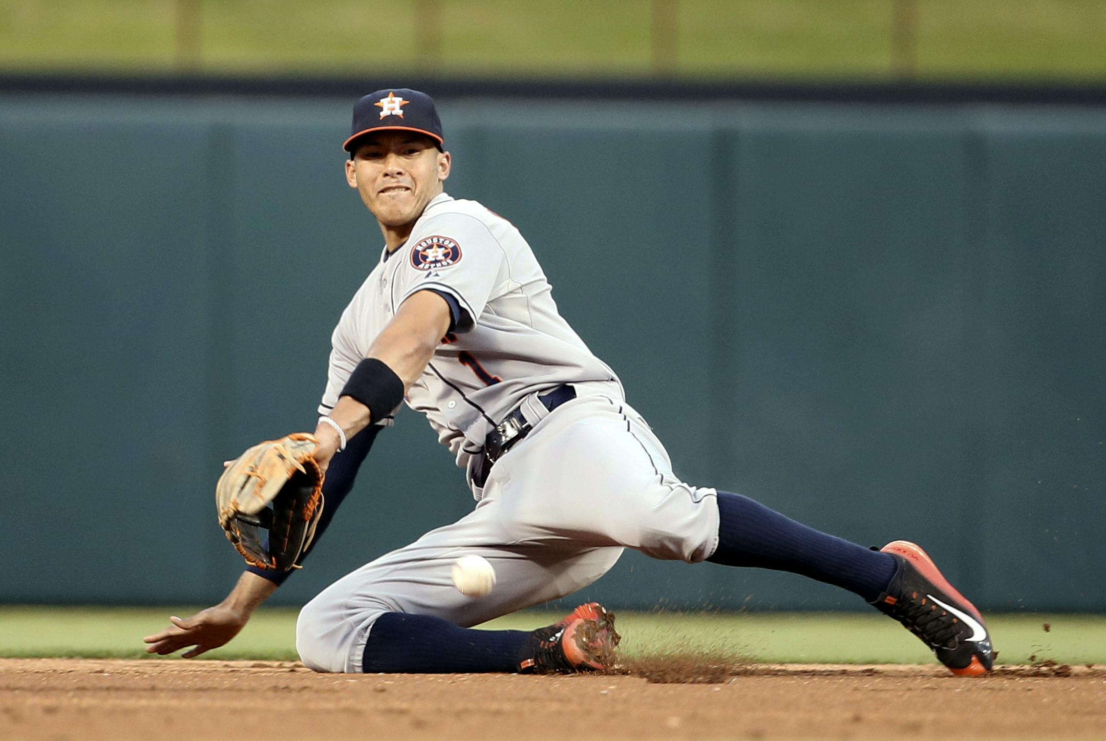 Houston Astros shortstop Carlos Correa (1) lays down to grab a ground out by Texas Rangers' Shin-Soo Choo in the second inning of a baseball game Monday, Sept. 14, 2015, in Arlington, Texas. (AP Photo/Tony Gutierrez)