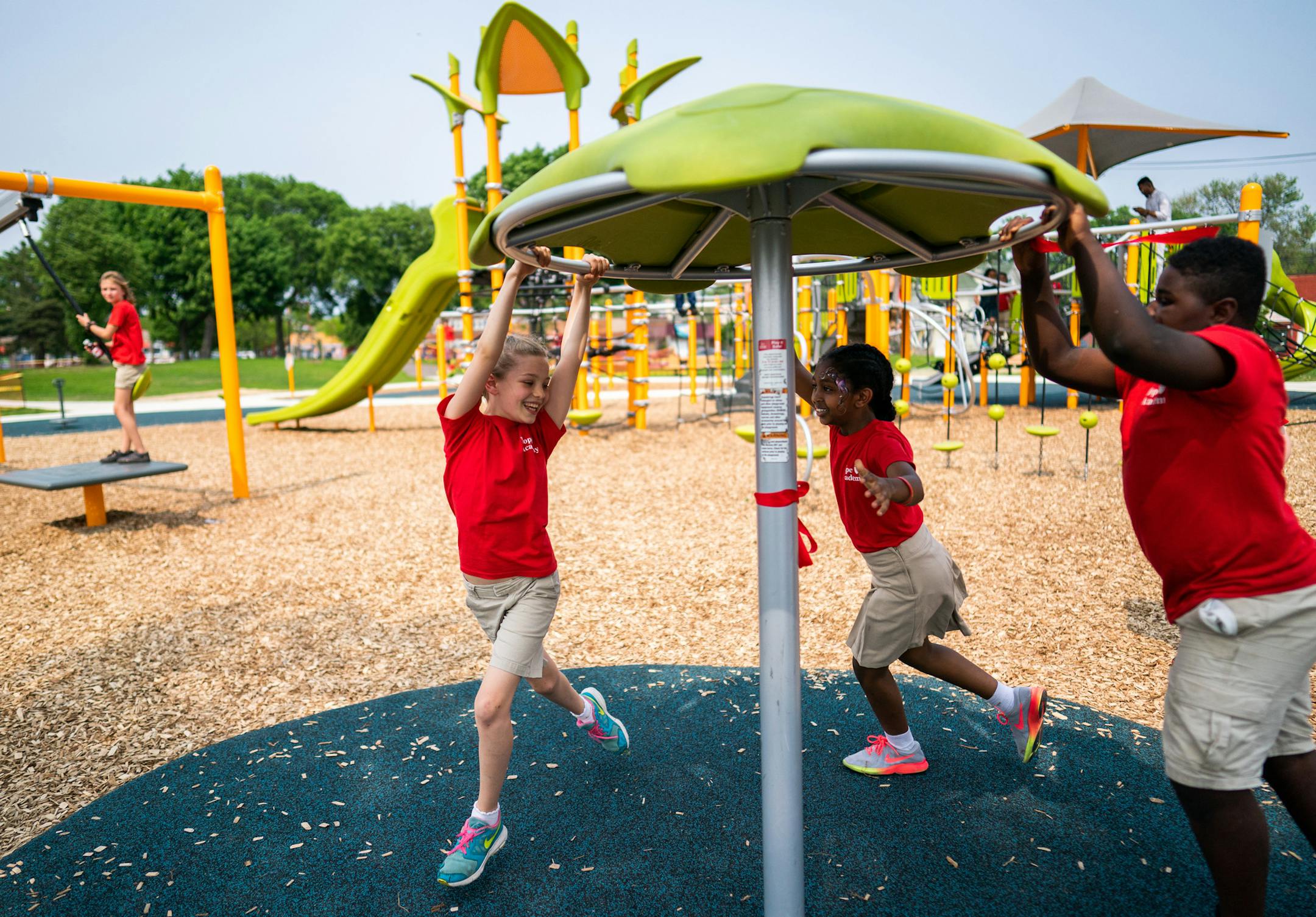 Hope Academy students Fraces Brown and Lidiya Temesgen spun on a new piece of playground equipment. ] MARK VANCLEAVE ¥ Park and neighborhood leaders celebrated the renovated Peavey Park at Franklin and Chicago avenues in south Minneapolis on Friday, May 31, 2019.