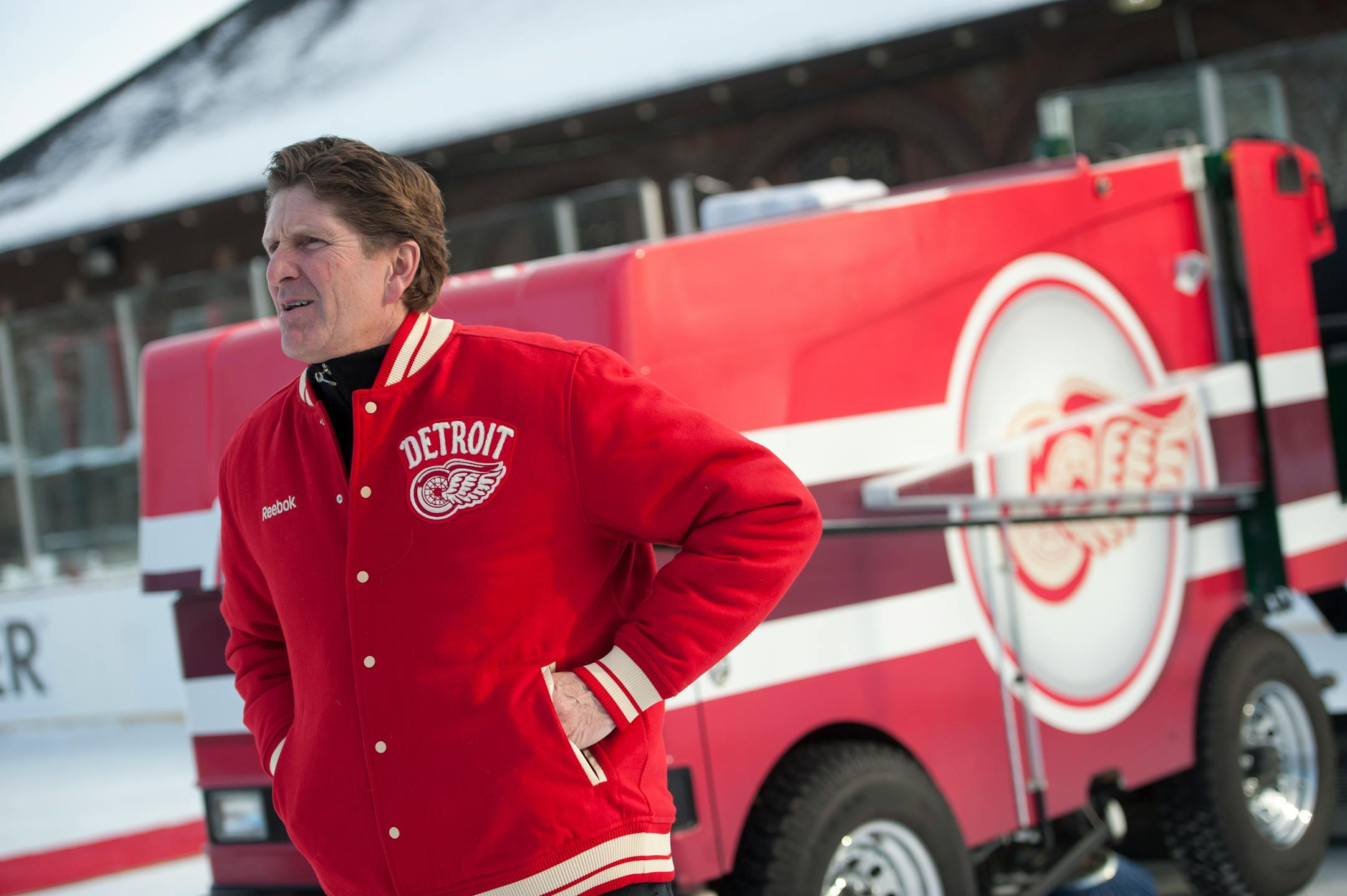 Detroit Red Wings head coach Mike Babcock waits on the rink near the newly donated Zamboni during an event at Clark Park in Detroit, Monday, Dec. 16, 2013. The NHL and the Red Wings unveiled a "Winter Classic Legacy Initiative" that will bring improvements to the ice rink including a new Zamboni and ice plant upgrades. (AP Photo/The Detroit News, David Guralnick) DETROIT FREE PRESS OUT; HUFFINGTON POST OUT.