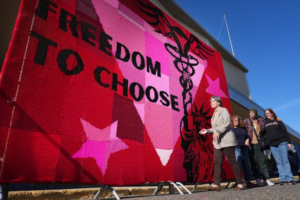 U.S. Rep. Betty McCollum stopped to view a massive crochet art instillation during the Rise for Roe event to rally voters for the DFL Saturday, Oct. 2