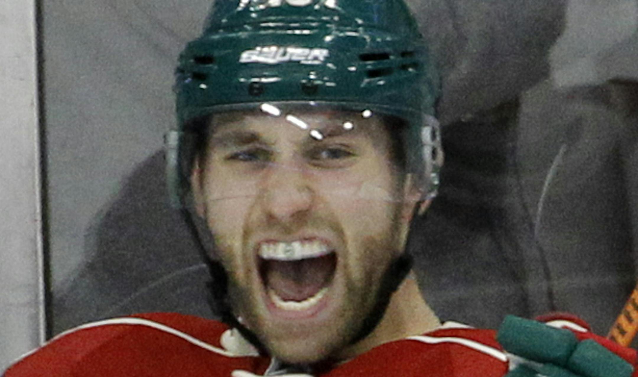 Minnesota Wild left wing Jason Zucker (16) celebrates after scoring on San Jose Sharks goalie Alex Stalock during the third period of an NHL hockey game in St. Paul, Minn., Tuesday, Jan. 6, 2015. The Sharks won 4-3 in overtime. (AP Photo/Ann Heisenfelt) ORG XMIT: OTKAH104