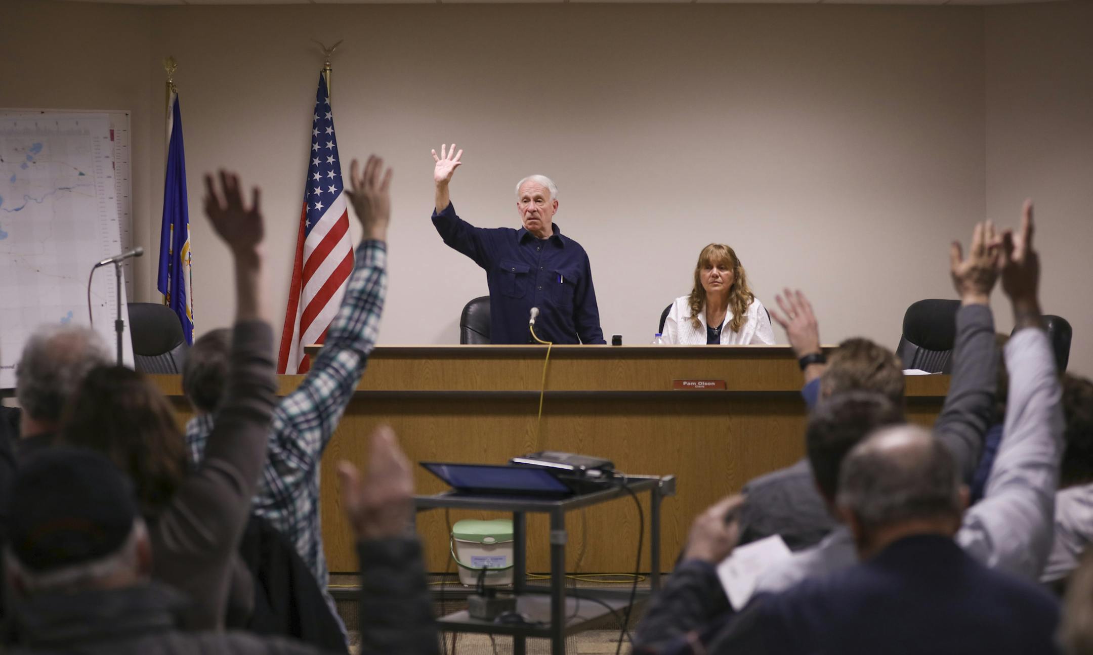 With meeting Moderator Tom Searing, standing, calling for the vote, Linwood Township residents raised their hands to vote in favor of the 2018 proposed tax levy. Town Clerk Pam Olson was seated next to him. ] JEFF WHEELER &#xef; jeff.wheeler@startribune.com The residents of Linwood Township &#xf1; Anoka County's last remaining township &#xf1; packed their new township hall for their annual town hall meeting on Tuesday night, March 14, 2017, where neighbors vote and set the annual tax levy.