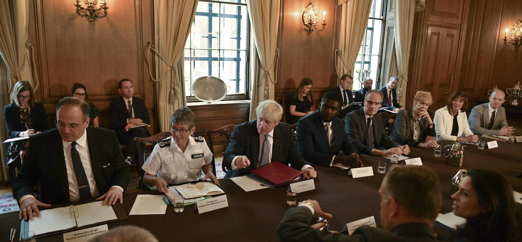 Britain's Prime Minister Boris Johnson, centre, speaks during a roundtable to improve the criminal justice system, at 10 Downing Street in London, Monday, Aug. 12, 2019. (Daniel Leal-Olivas/Pool Photo via AP) ORG XMIT: AMB138