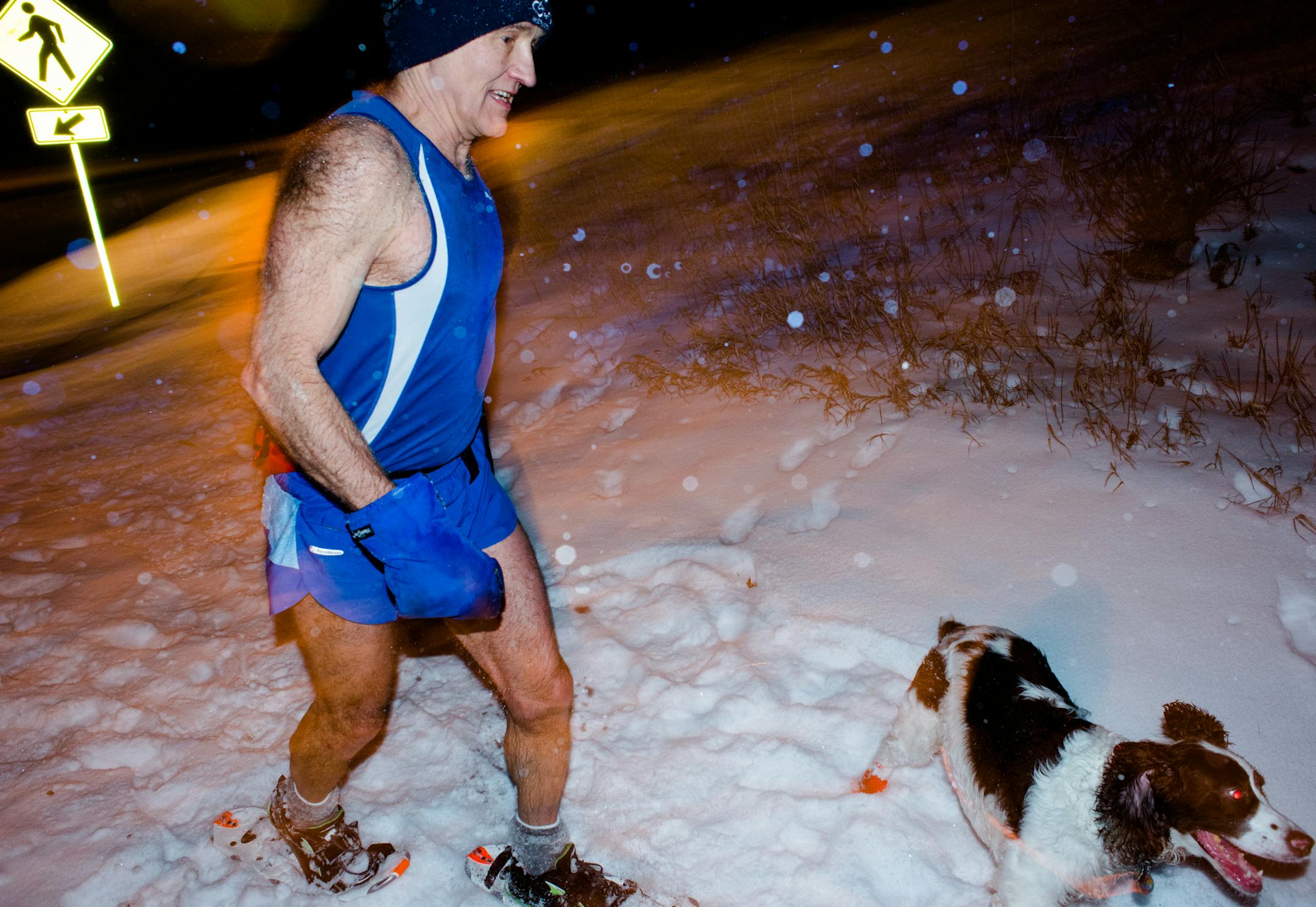 Jim McDonell, of Woodbury, ran along a dark trail with his one-eyed dog Pohe in Carver Lake Park. ] Mark Vancleave - mark.vancleave@startribune.com * Runners participated in a night snowshoe run in Carver Lake Park, Woodbury on Wednesday, Jan. 6, 2015.