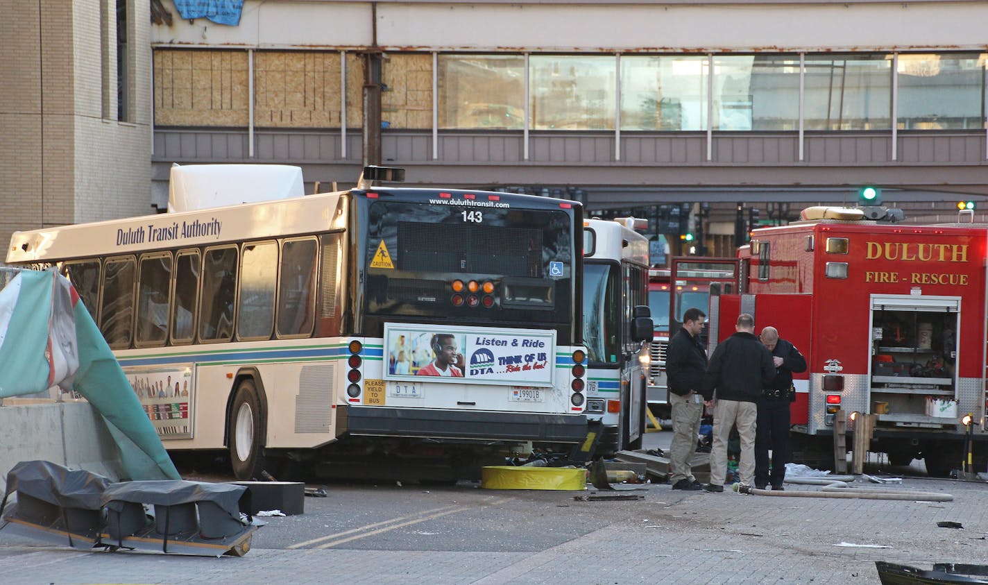 Authorities investigate a crash involving two DTA buses in the 400 block of West Superior Street on Tuesday morning.