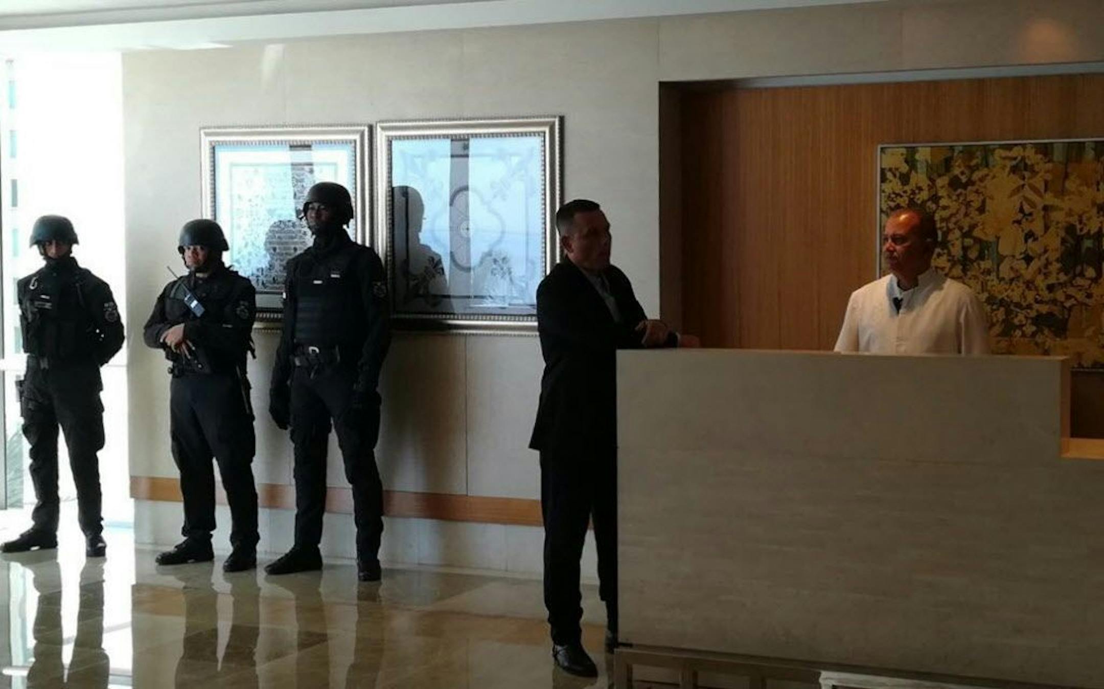 Security forces stand in the lobby of the Trump Ocean Club International Hotel and Tower in Panama City, Wednesday, Feb. 28, 2018. For the fourth time in one week on Tuesday, police were called to the property due to a fight over Trump Hotels' contract to manage the 70-story luxury high rise after the owners voted to remove Trump's name and fire his hotel management company.