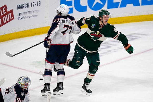 Minnesota Wild left wing Kirill Kaprizov, right, celebrates after scoring the game-winning goal to defeat the Columbus Blue Jackets during overtime of
