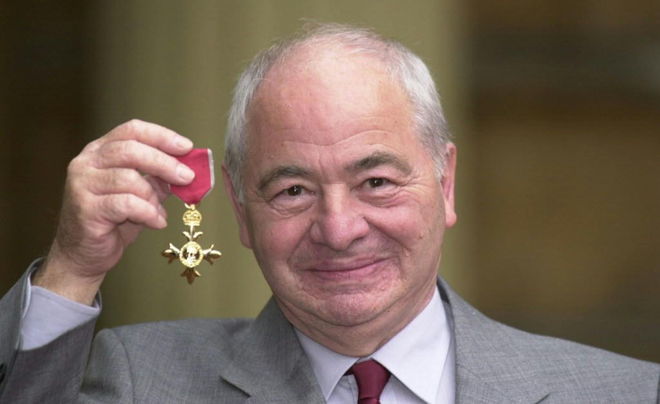 FILE - This is a Oct. 27, 2000 file photo of British author Colin Dexter after receiving an Order of the British Empire. Writer Colin Dexter, who created music-loving Oxford detective Inspector Morse, has died aged 86. Publisher Pan Macmillan said Dexter died Tuesday March 21, 2017 at his home in Oxford England.?