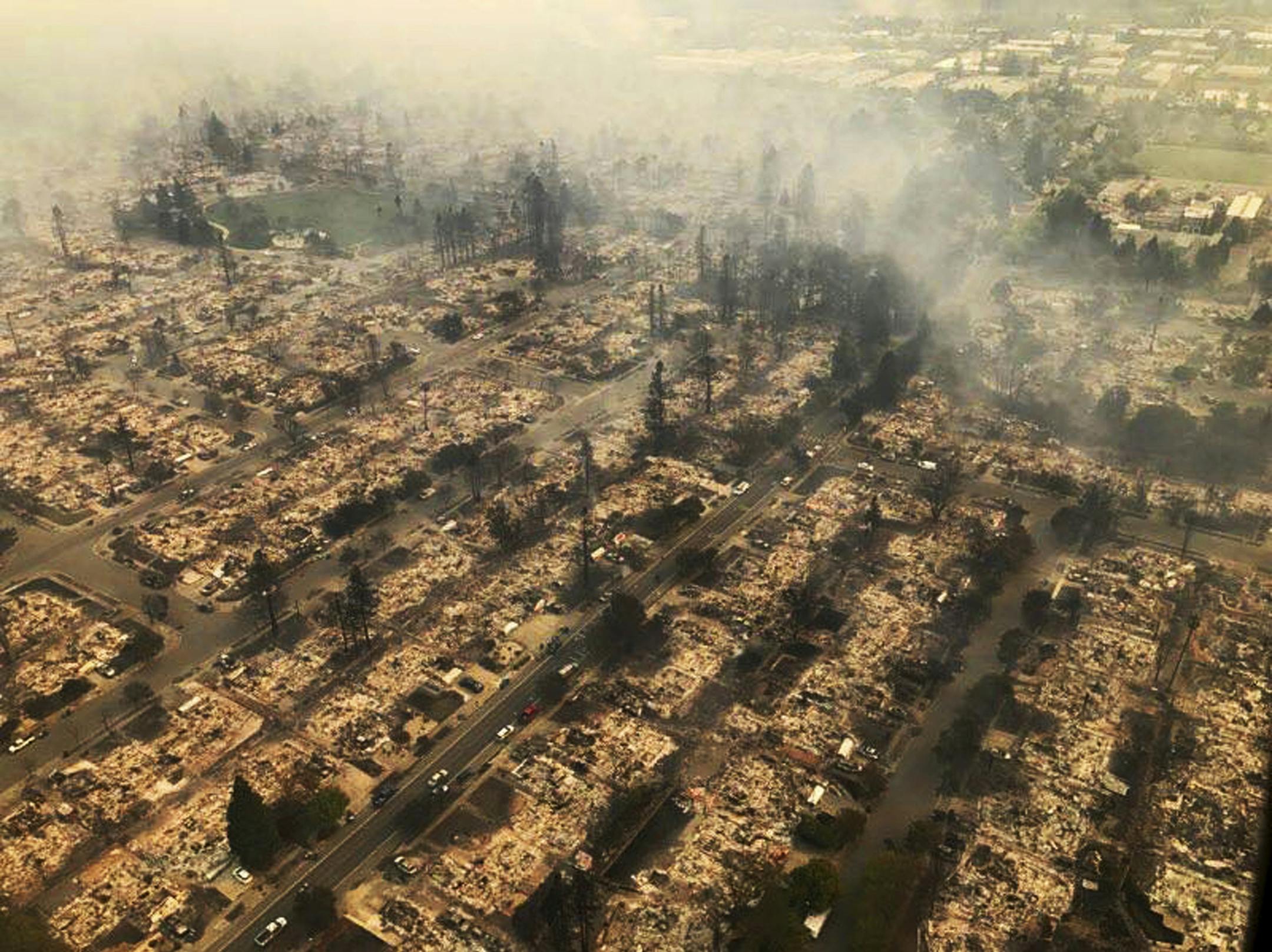 This aerial photo provided by the California Highway Patrol Golden Gate Division shows some of hundreds of homes destroyed in a wind-driven wildfire that swept through Santa Rosa, Calif., early Monday, Oct. 9, 2017. (California Highway Patrol Golden Gate Division via AP)