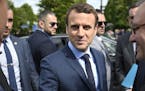 French centrist presidential candidate Emmanuel Macron, center, arrives for a ceremony marking 102nd anniversary of the slaying of Armenians by Ottoma