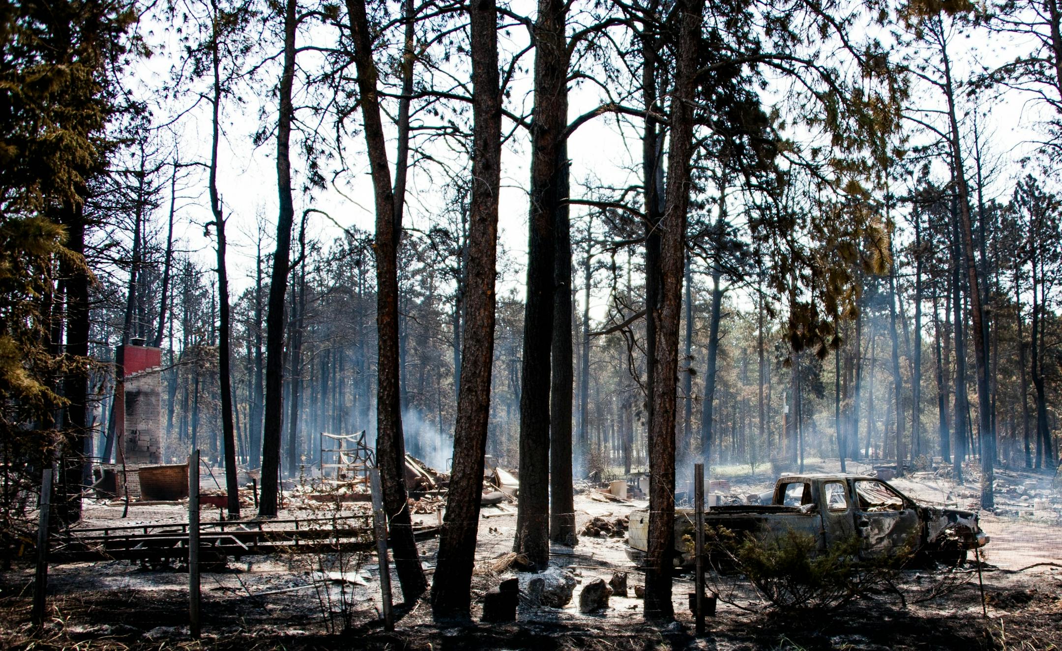 A structure on Herring Road smolders after being burnt to the ground by a quickly advancing Black Forest fire Thursday, June 13, 2013.