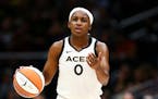 Las Vegas Aces guard Jackie Young (0) gestures while dribbling during the first half in Game 3 of a WNBA basketball semifinal playoff series Sunday, S