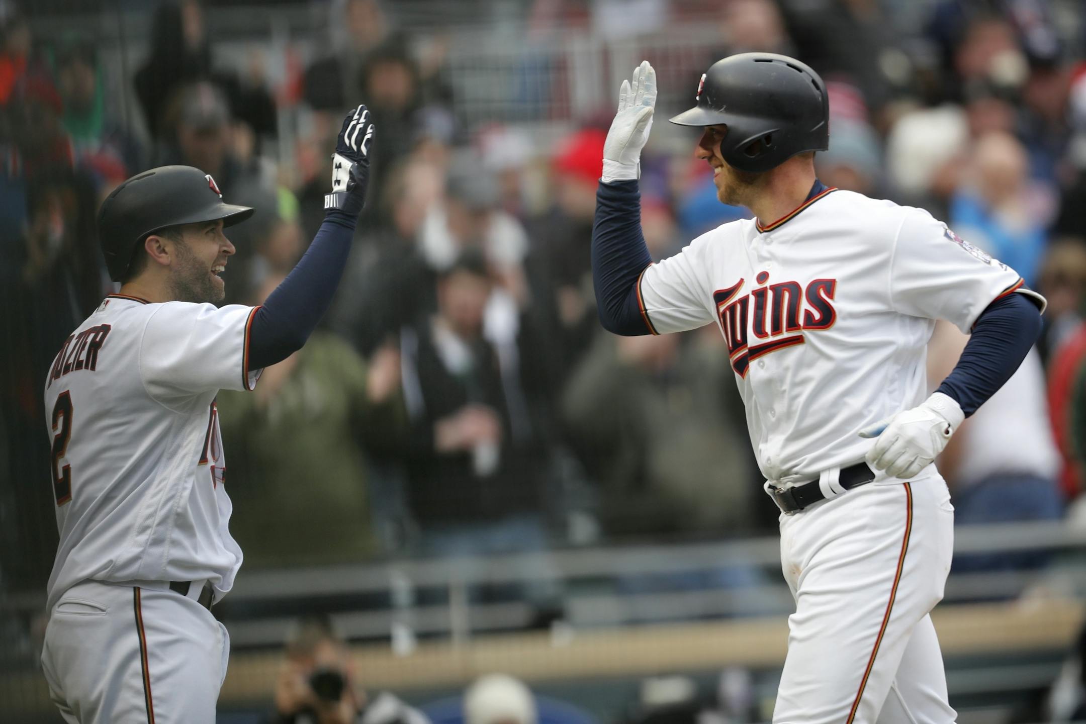 Minnesota Twins catcher Mitch Garver (23), right, celebrates hitting a home run in the 7th inning with teammate Minnesota Twins second baseman Brian Dozier (2).