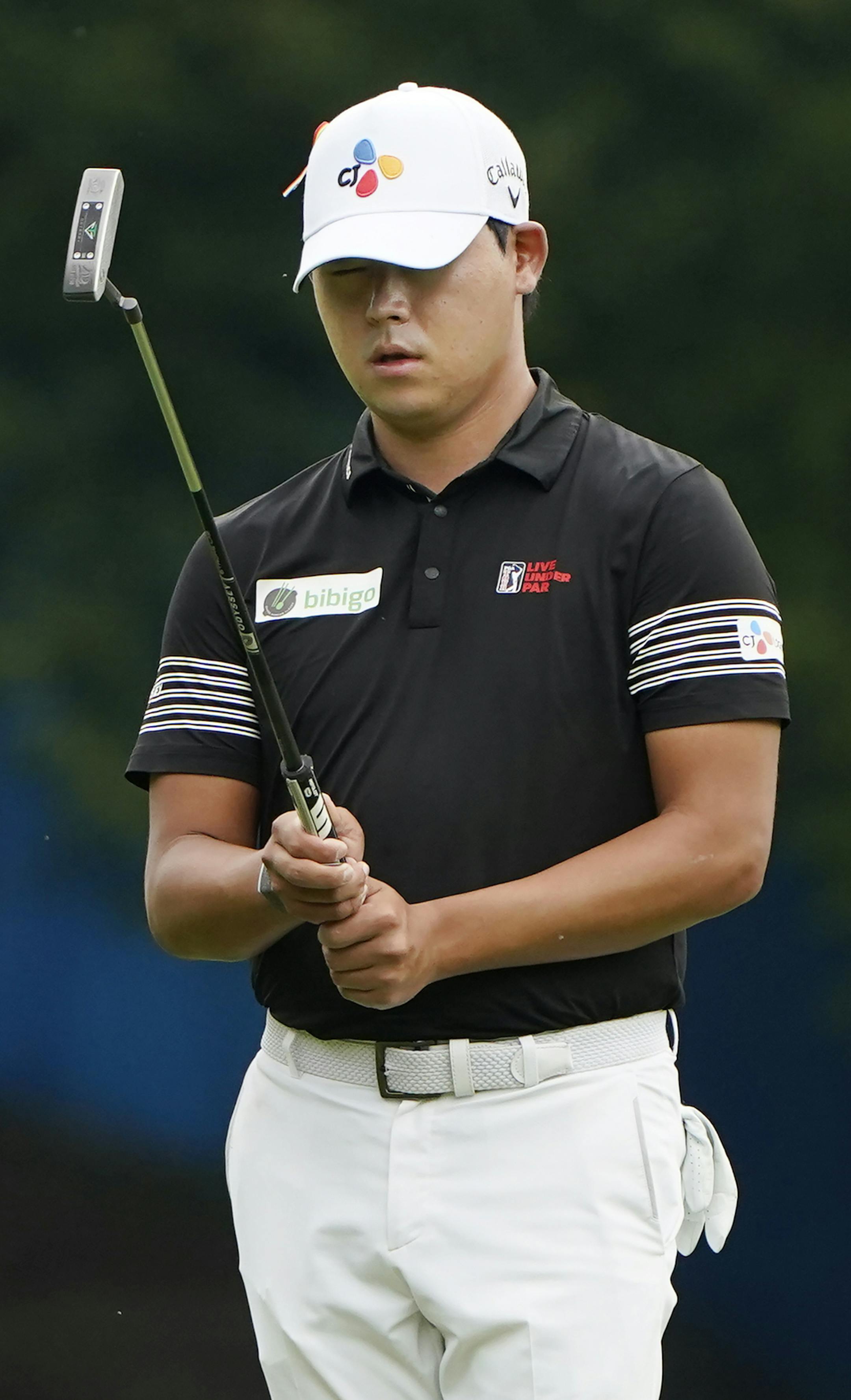 Si Woo Kim, of South Korea, lines up a putt on the first hole during the third round of the Wyndham Championship golf tournament at Sedgefield Country Club on Saturday, Aug. 15, 2020, in Greensboro, N.C. (AP Photo/Chris Carlson)
