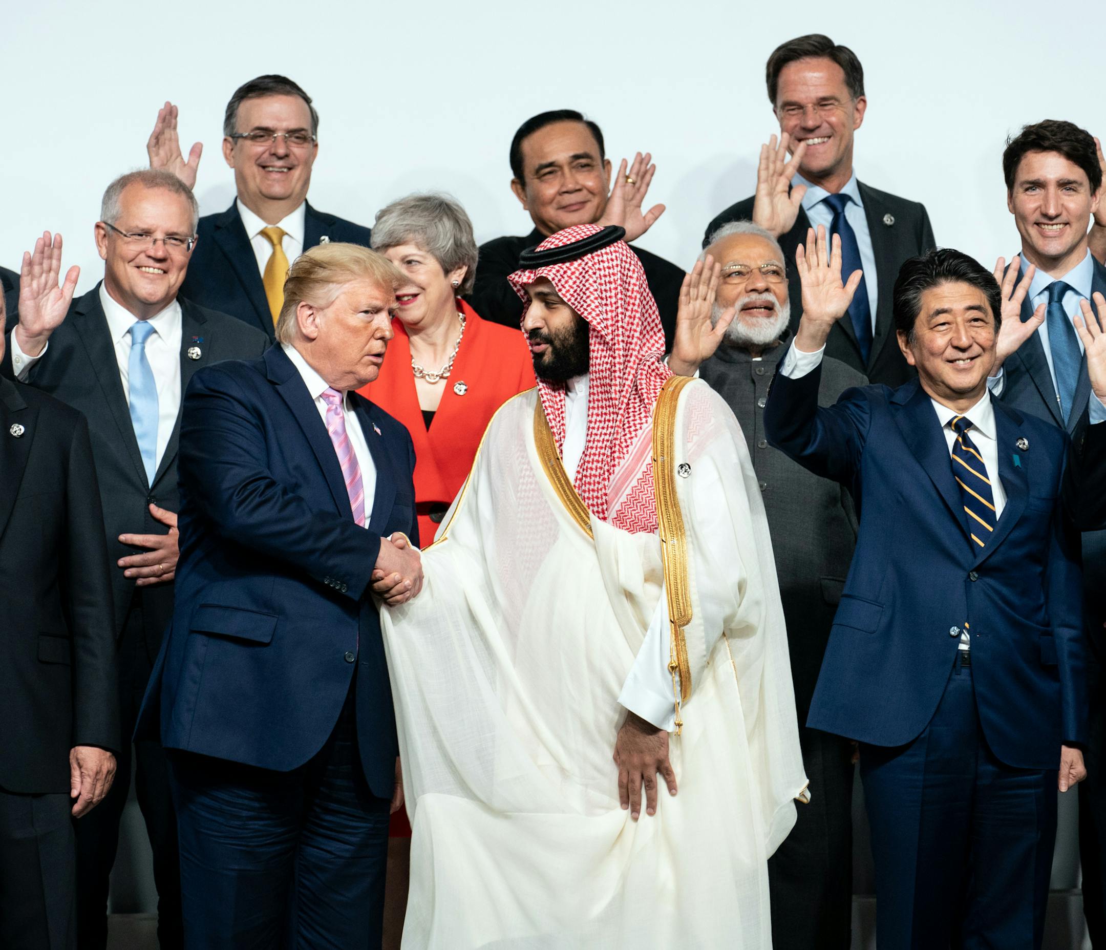 President Donald Trump shakes hands with Crown Prince Mohammed bin Salman of Saudi Arabia while posing with other world leaders for a group photo at the Group of 20 summit in Osaka, Japan on Friday, June 28, 2019. (Erin Schaff/The New York Times)