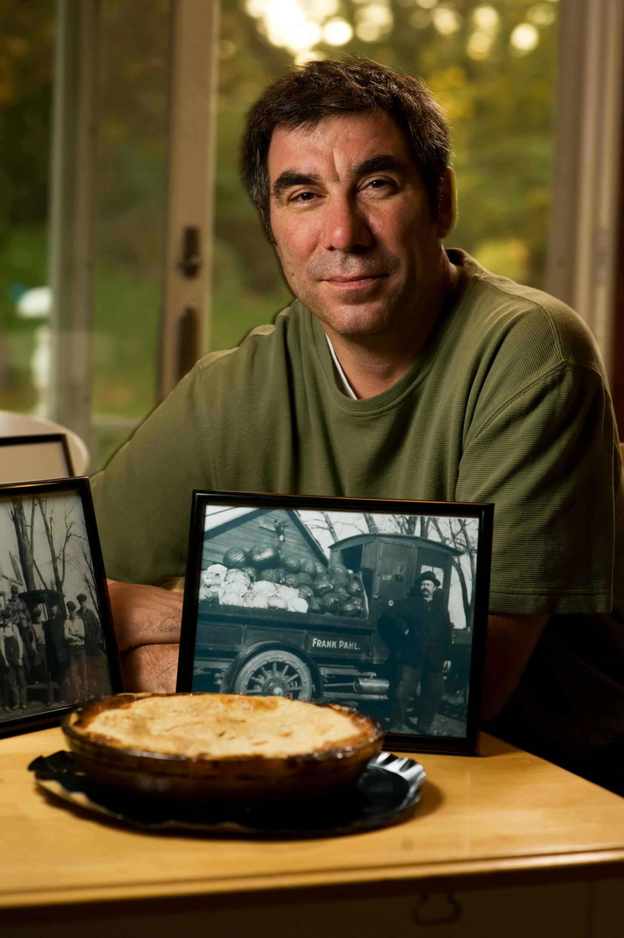Greg Faust with a photo of his grandfather's farm in Bloomington taken in the 1930s. And yes, that is a rhubarb pie.