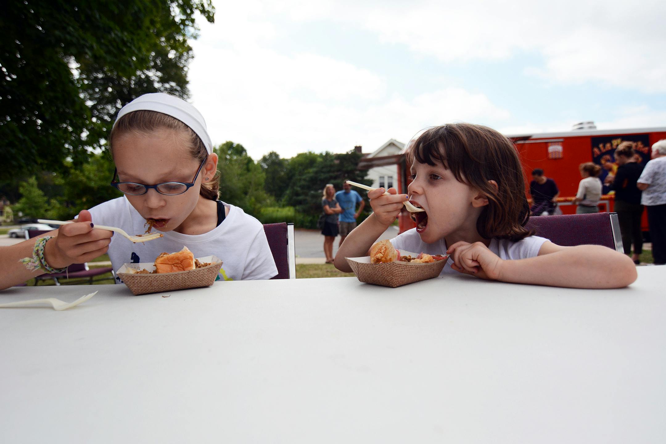 Clara, 10, and Ruth, 6, Lippert enjoyed sliders from A La Plancha at a recent Food Truck Tuesday in Northfield. Photo by Liz Rolfsmeier, Special to the Star Tribune