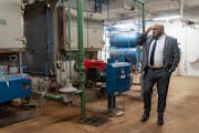 Scott Redd, CEO and President of Sabathani Community Center, looks at the two 60-year-old gas boilers in the basement of Sabathani Community Center in