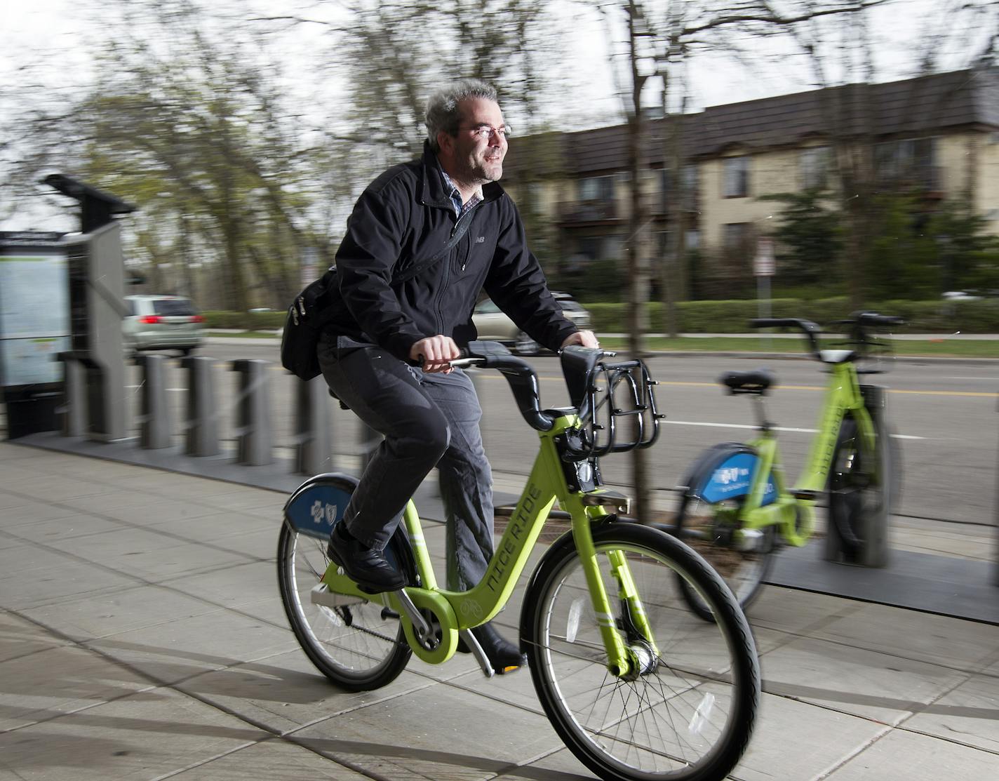 Ed Kohler, riding along East Lake Street in Minneapolis, uses Nice Ride bicycles to get around town.