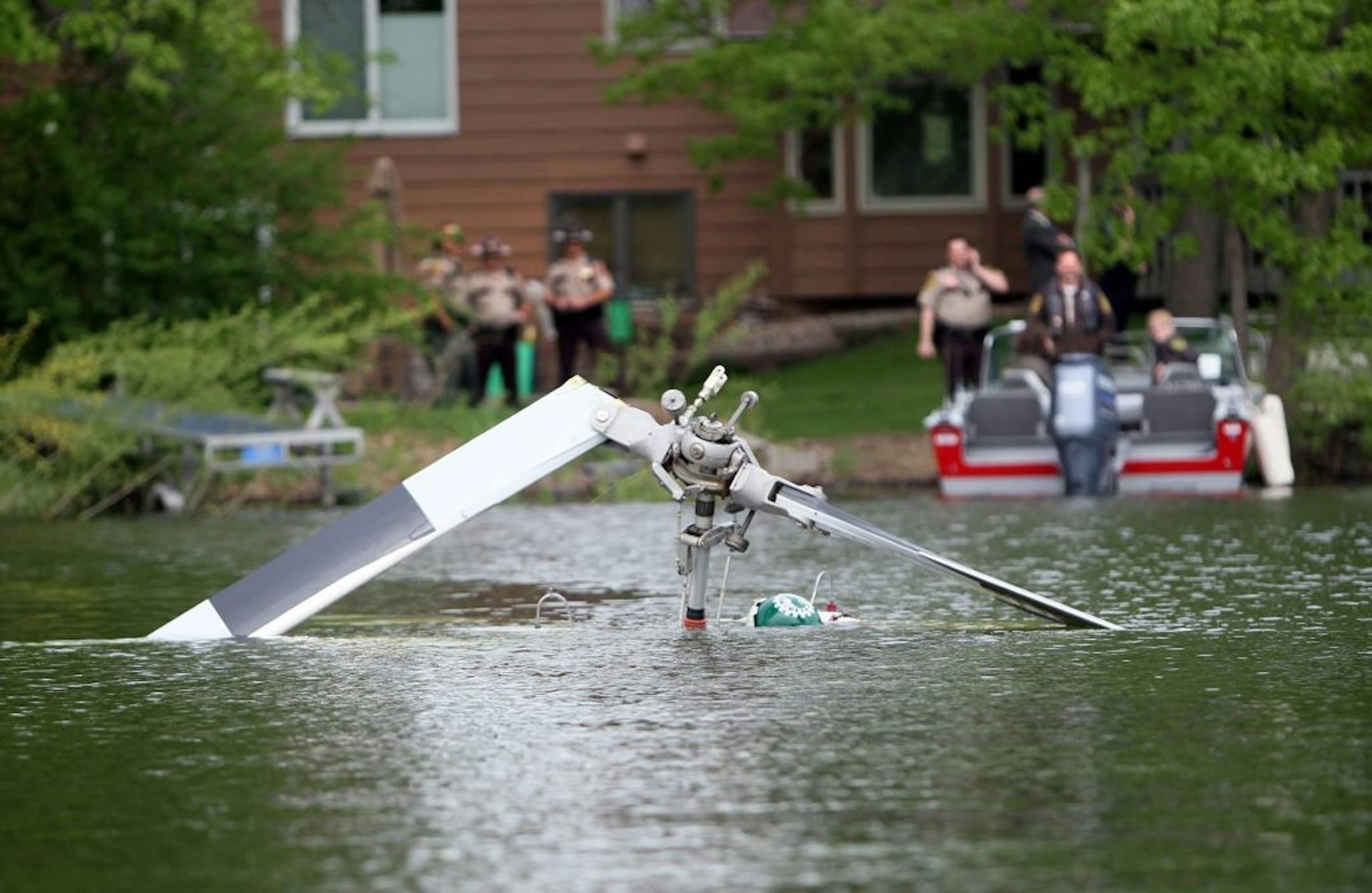 The remains of a helicopter that crashed into Lake Marion in Lakeville was near the shore that was occupied by the police and sheriff.