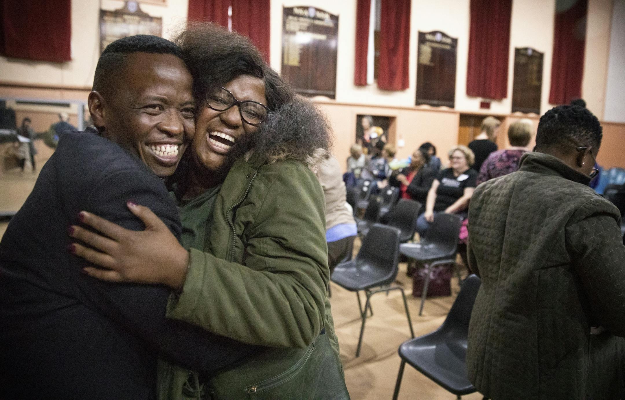 South African soprano Goitsemang Lehobye, right, an alumni of the Gauteng Choristers greets a friend who is in the group, Sizwe Nkwanyana, before rehearsal.