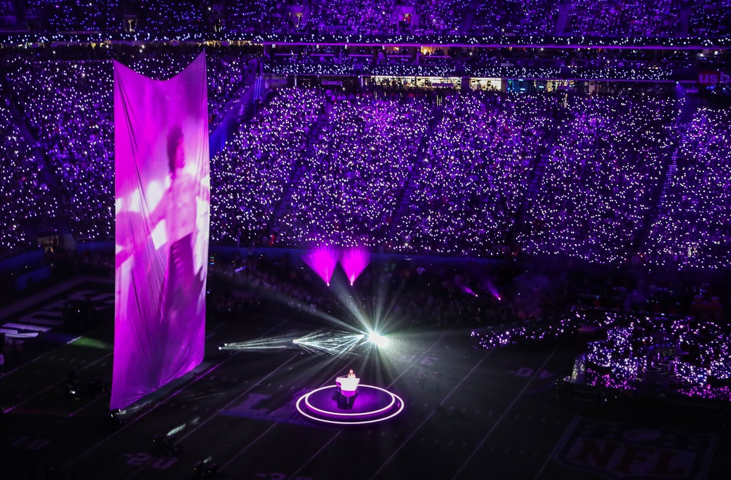 Justin Timberlake pays tribute to Prince, singing "I Would Die 4 U," as video of the music icon performing in "Purple Rain" is projected on a large screen during the Super Bowl halftime show.