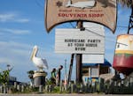 Visitors pass a restaurant closed in advance of Beryl, Saturday, July 6, 2024, in Port Aransas, Texas.