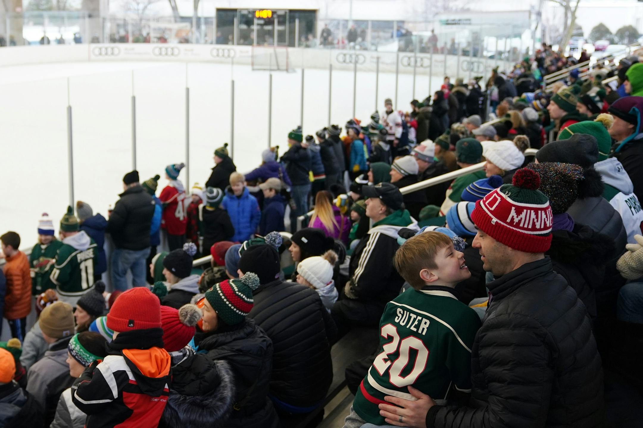 Dan Reich of Minnetonka sat with this son Carter, 5, as they watched during the Wild's outdoor practice Thursday.