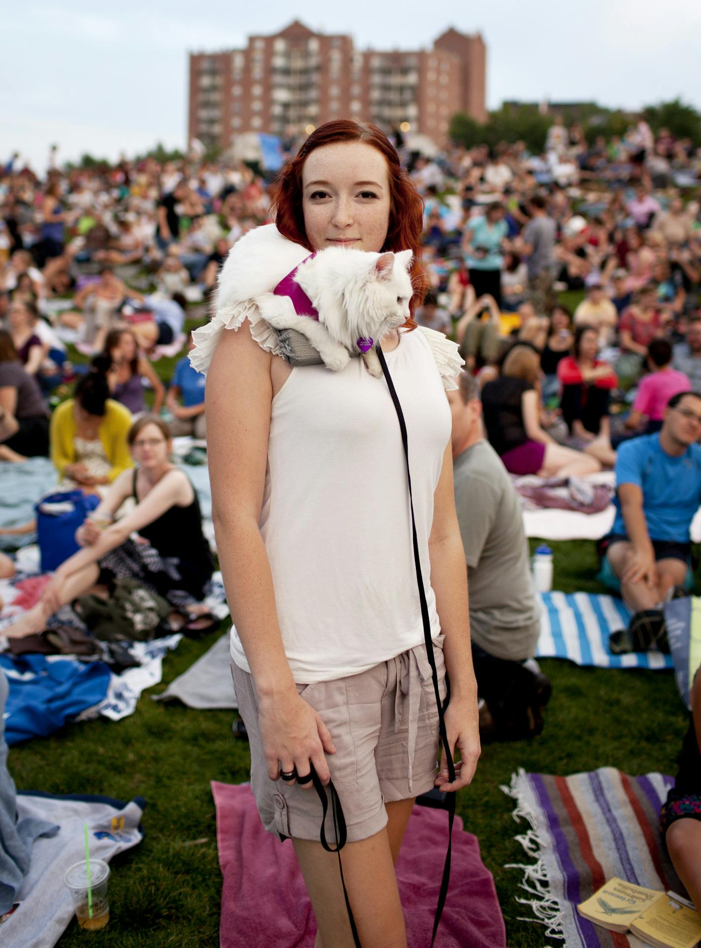 Vanessa Gadberry stands with her cat on her shoulder at the Walker Art Center's first Internet Cat Video Film Festival, in Minneapolis, Aug. 30, 2012. The festival attracted an estimated 10,000 people, easily double what organizers expected. (Jenn Ackerman/The New York Times) ORG XMIT: MIN2012090510060619 ORG XMIT: MIN1405231744480763