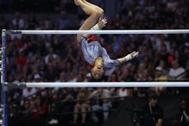 Suni Lee of St. Paul competes in the uneven bars during Day 2 of the United States women's gymnastics Olympic trials at Target Center on Sunday.