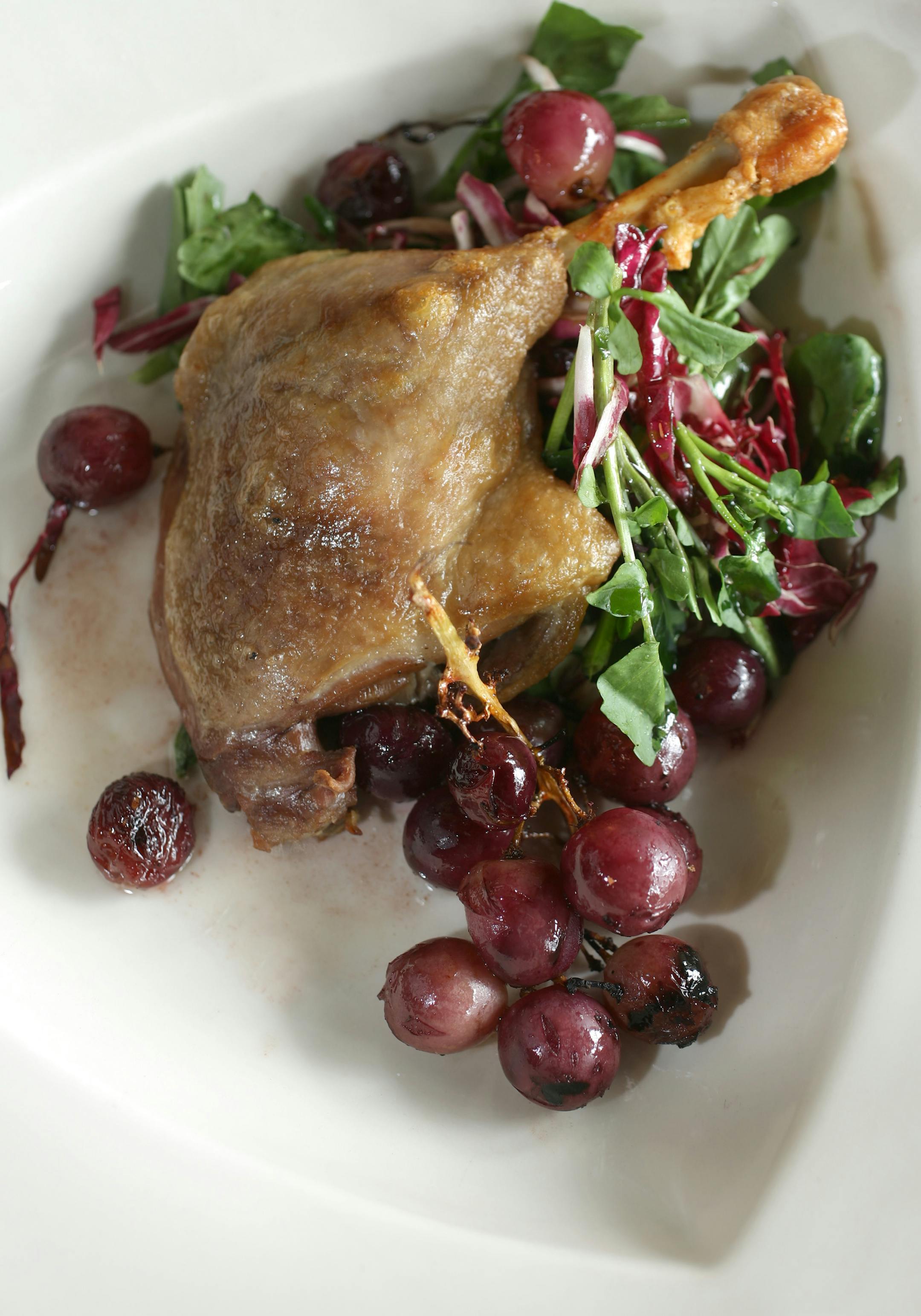 Duck confit with radicchio, watercress and grilled grapes.